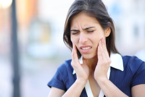 stressed-woman-suffering-tmj-disorder